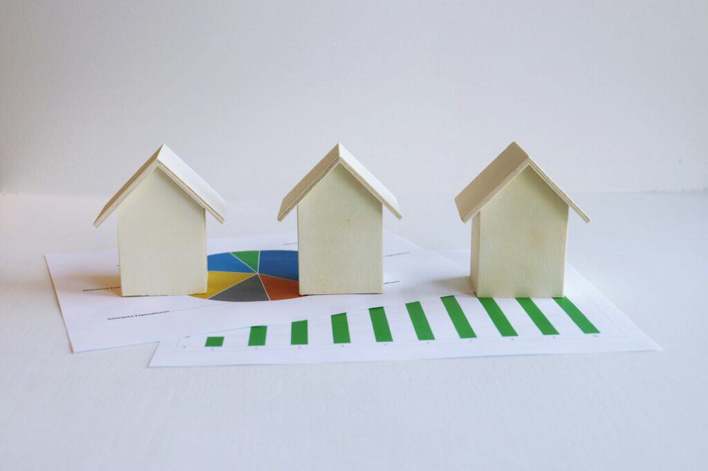 Mortgage Loan Limits Explained: Conventional, FHA, VA, USDA and Non-QM 1 Several small model houses on paperwork, illustrating mortgage loan limits by property type.