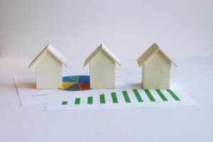 About Us 2 Several small model houses on paperwork, illustrating mortgage loan limits by property type.