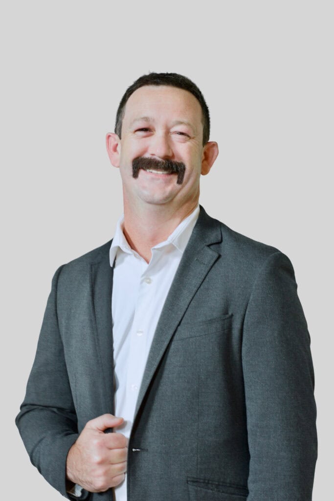 Justin Harwell in suit with neutral background